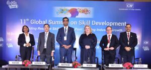 Six people standing on stage at the 11th Global Summit on Skill Development.