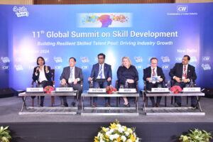 Panelists seated on stage at the 11th Global Summit on Skills with a blue backdrop.