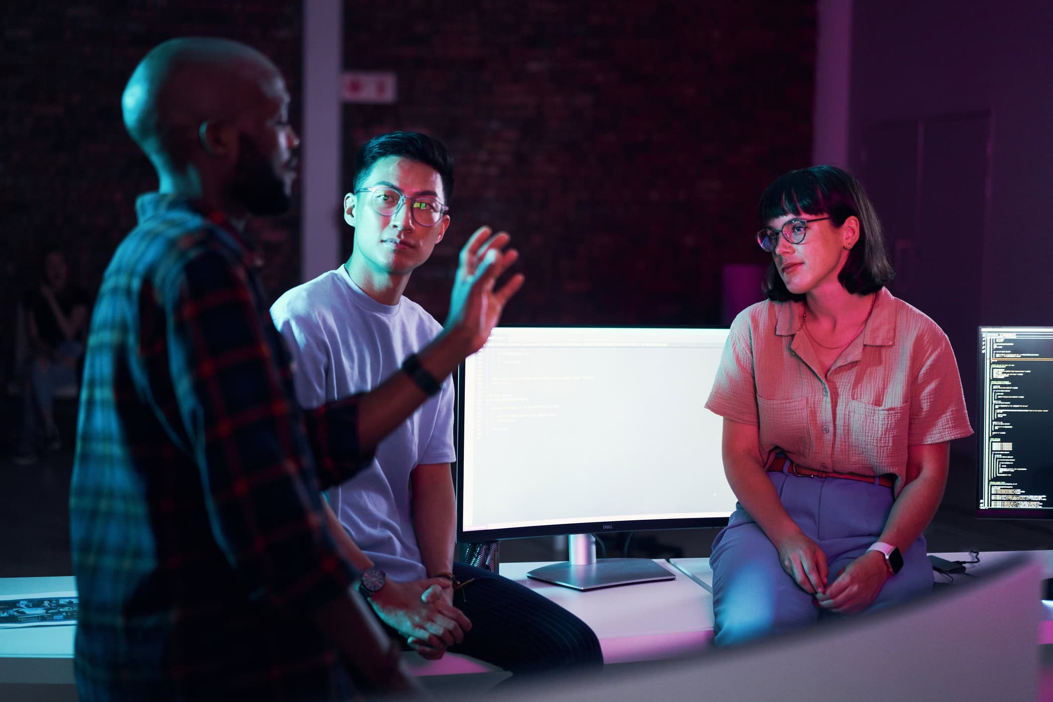 a group of people sitting in front of a computer