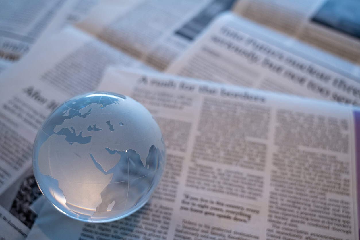 glass globe on newspapers