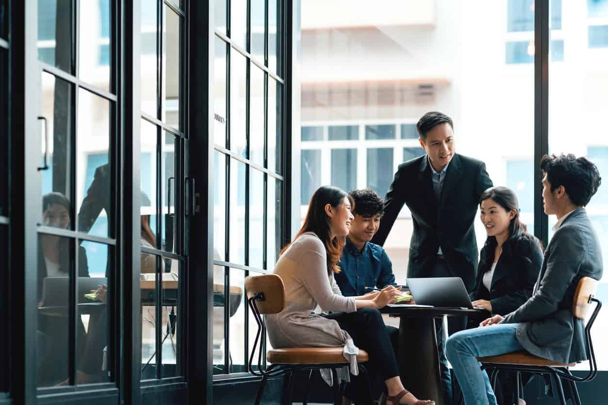 Group of professionals having a meeting in a modern office setting.