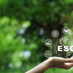 An open hand interacting with virtual icons representing ESG factors, overlaid on a blurred green nature background.